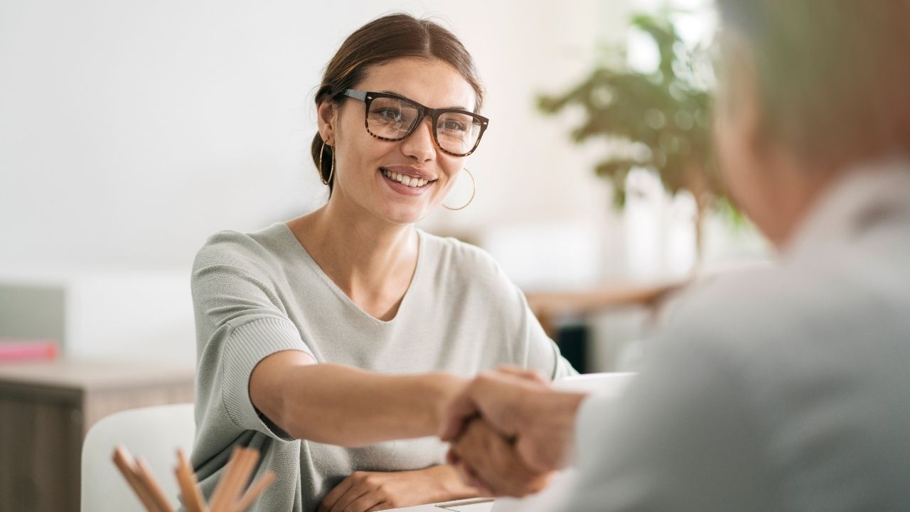 woman shaking hands with man